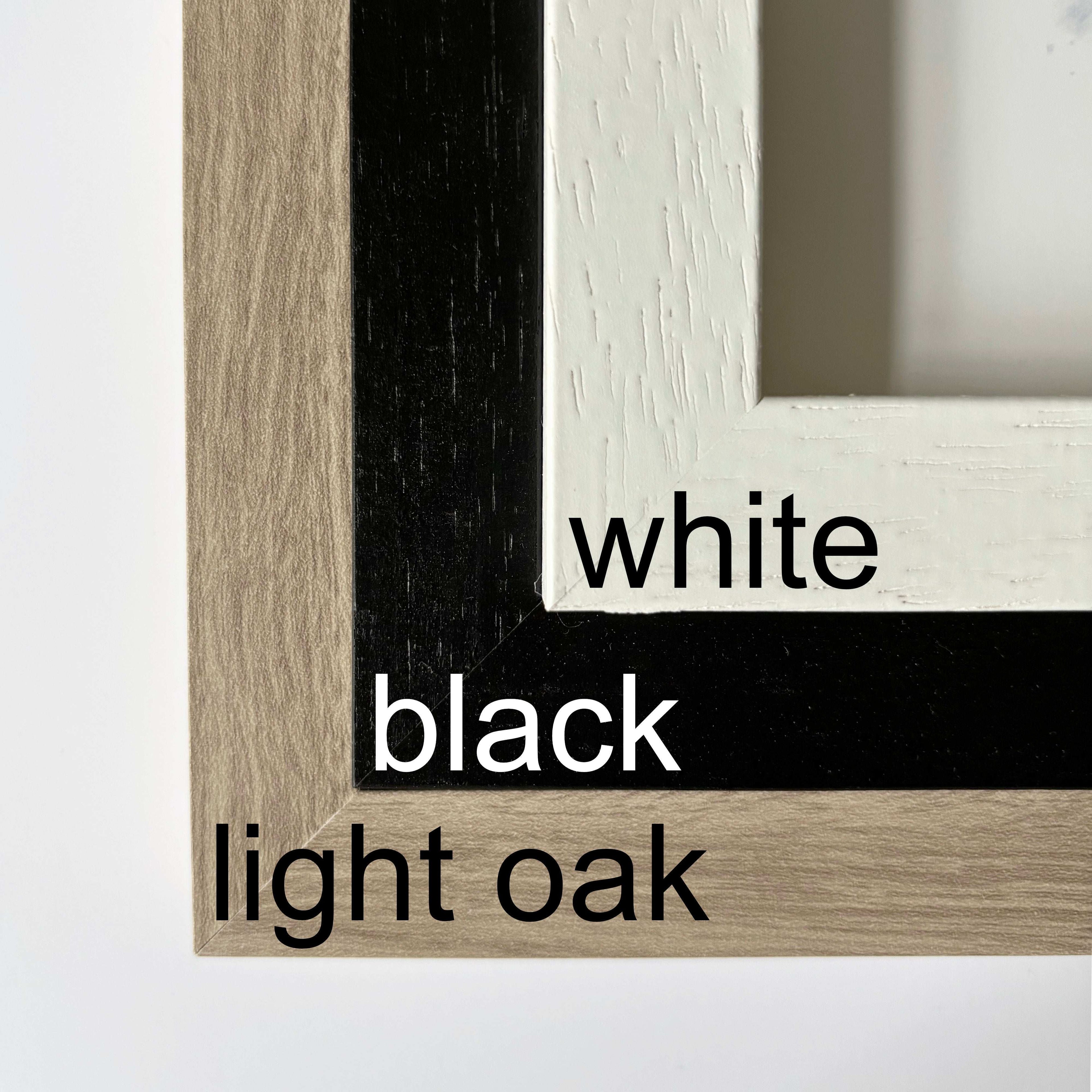 Display of optional wooden print frames: white, black, and light oak colour choices