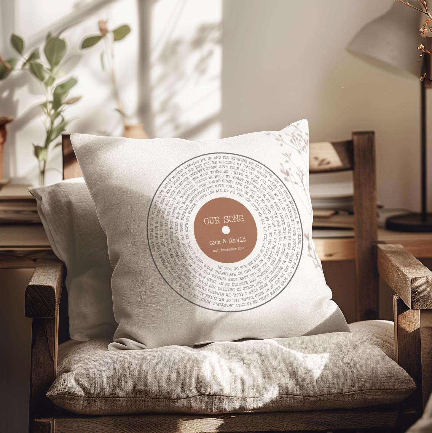 Personalised cushion featuring custom song lyrics in a spiral vinyl record design, with couple's names and date