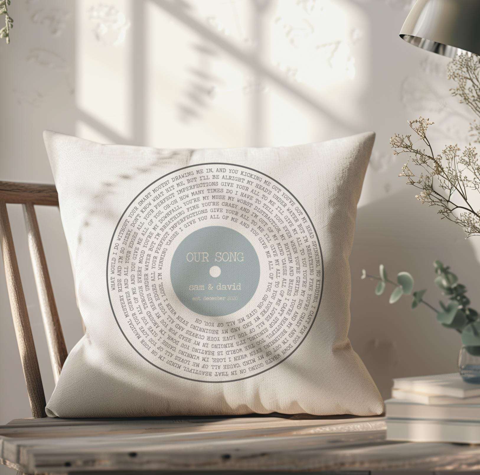 Personalised cushion featuring custom song lyrics in a spiral vinyl record design, with couple's names and date