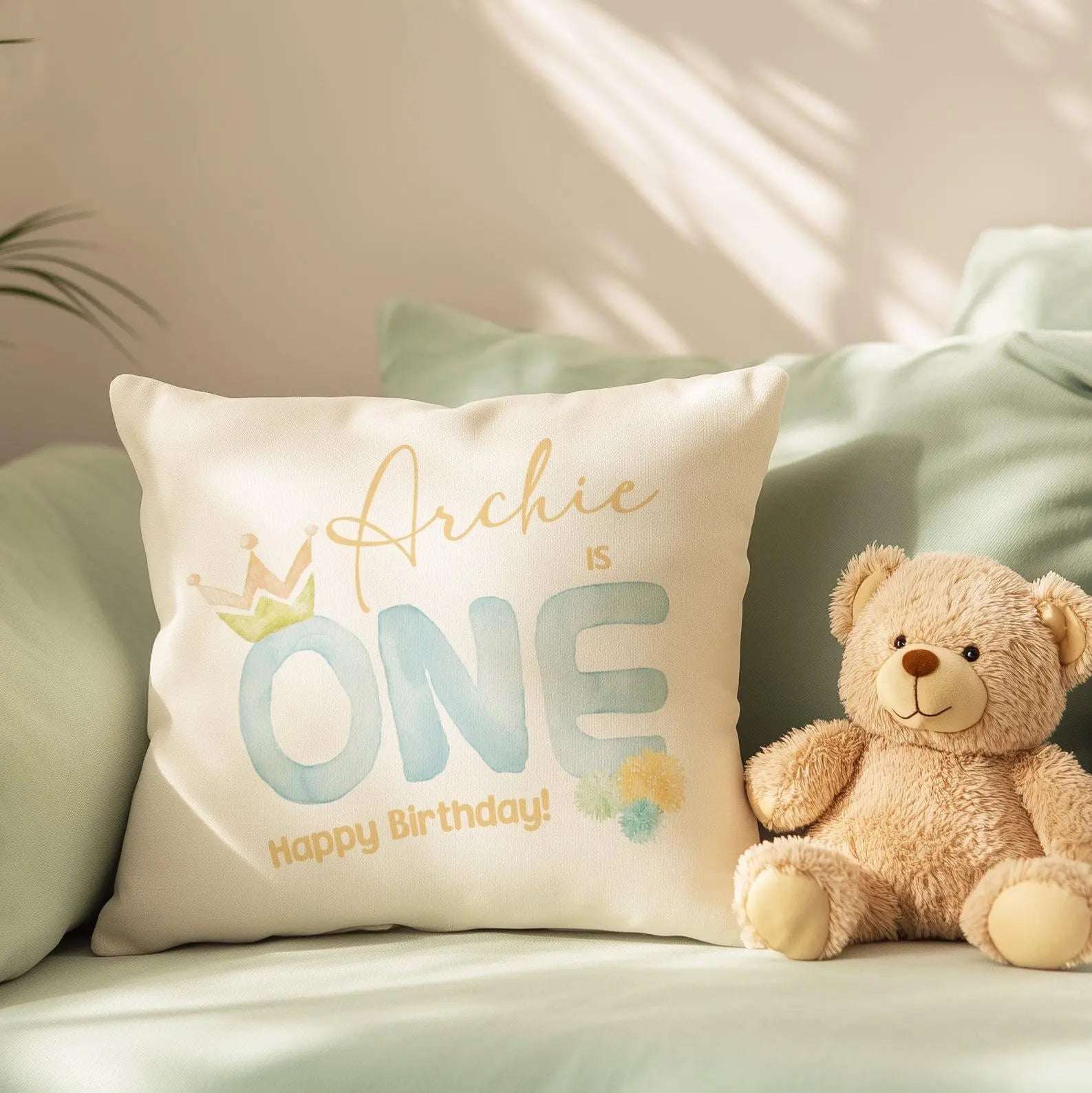 Personalised 1st birthday cushion with custom text and design, available in soft pink and gentle blue for a baby boy or girl nursery