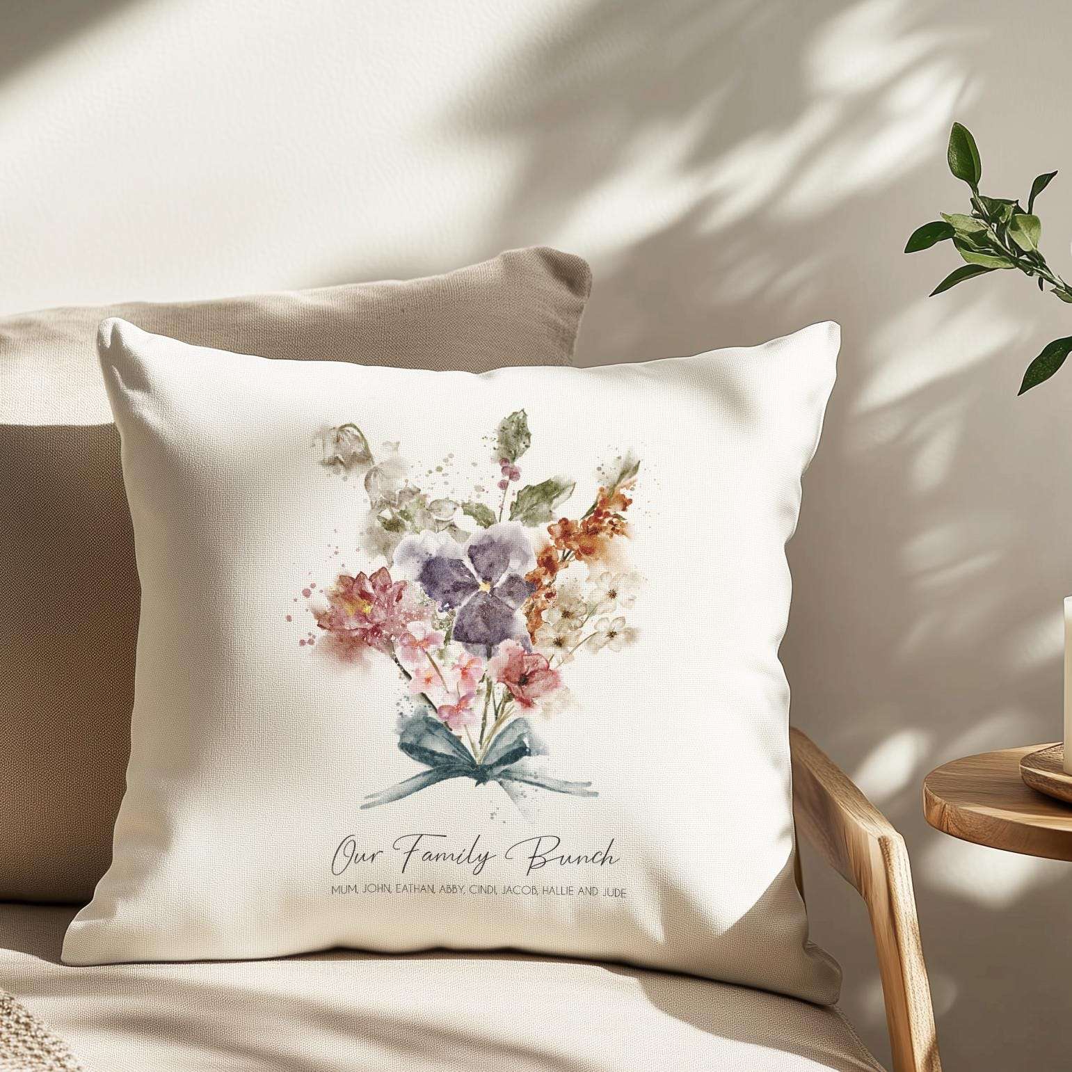 Personalised family cushion featuring a watercolour bouquet of birth month flowers with family and individual names