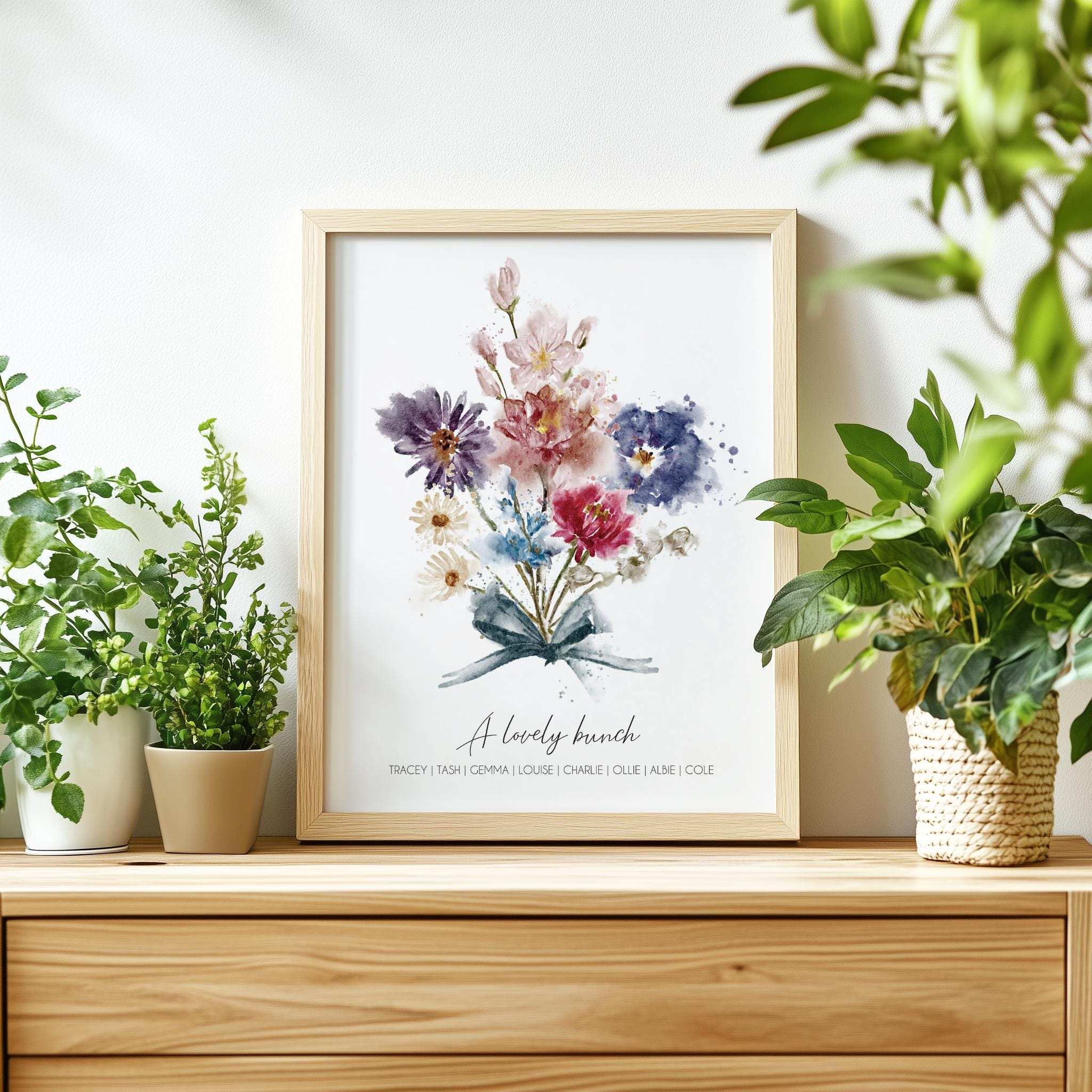 Personalised print with watercolour birth month flowers in a 'grandma's garden' arrangement, framed and ready for wall display