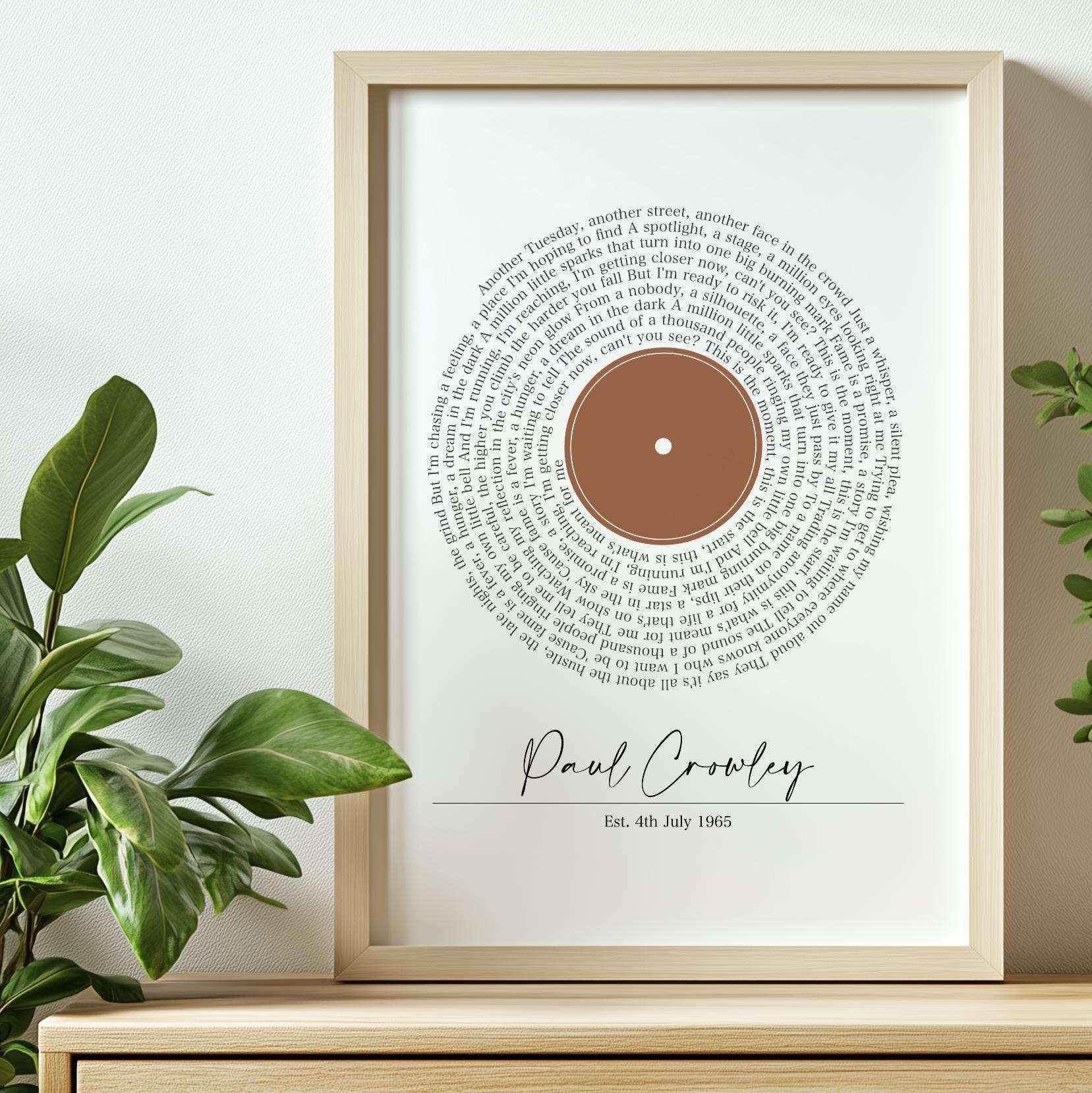 Personalised print featuring song lyrics in a classic spiral vinyl record design, custom text underneath