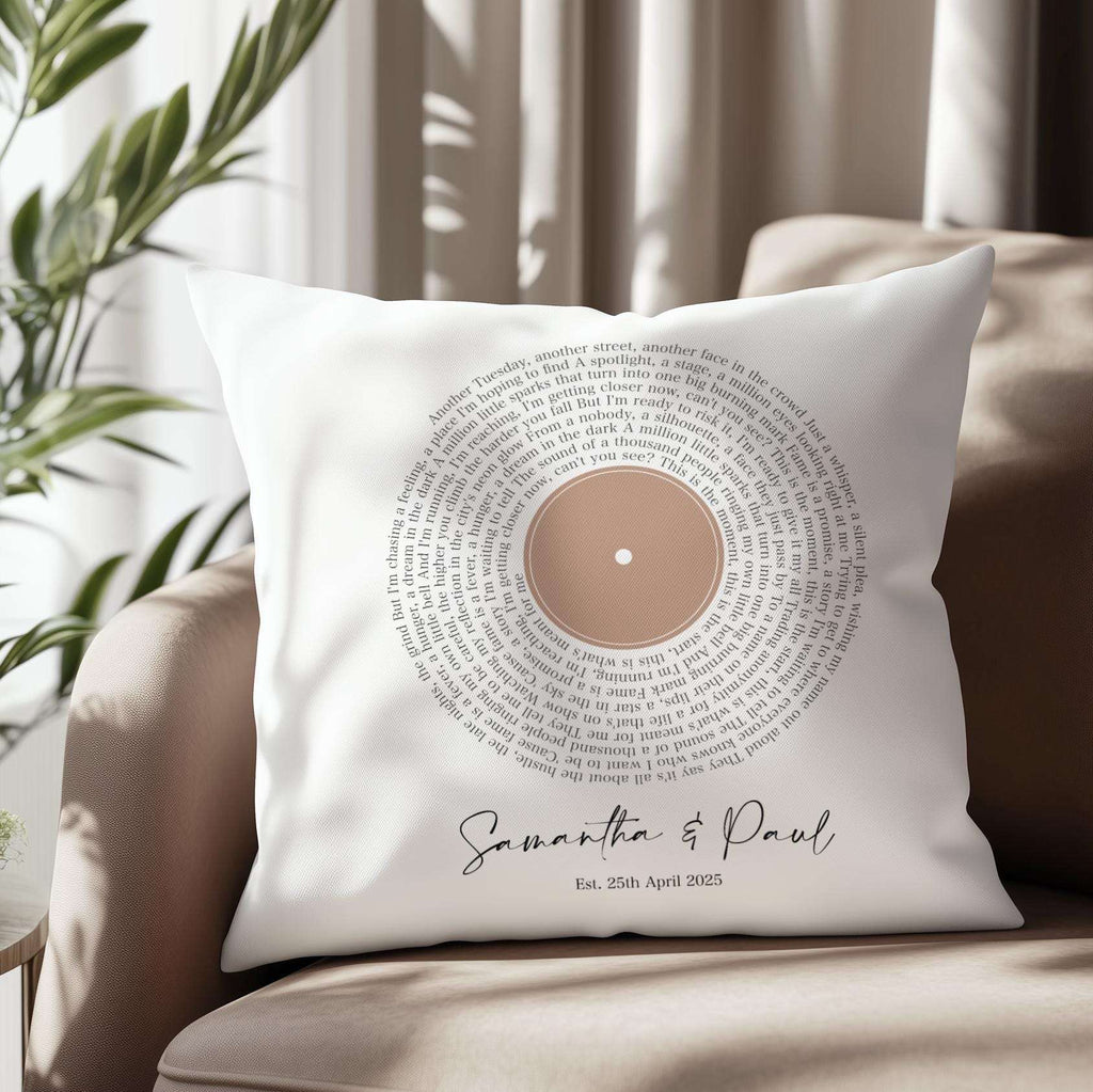 Custom cushion featuring first dance song lyrics in a spiral vinyl record design, personalised with names and date