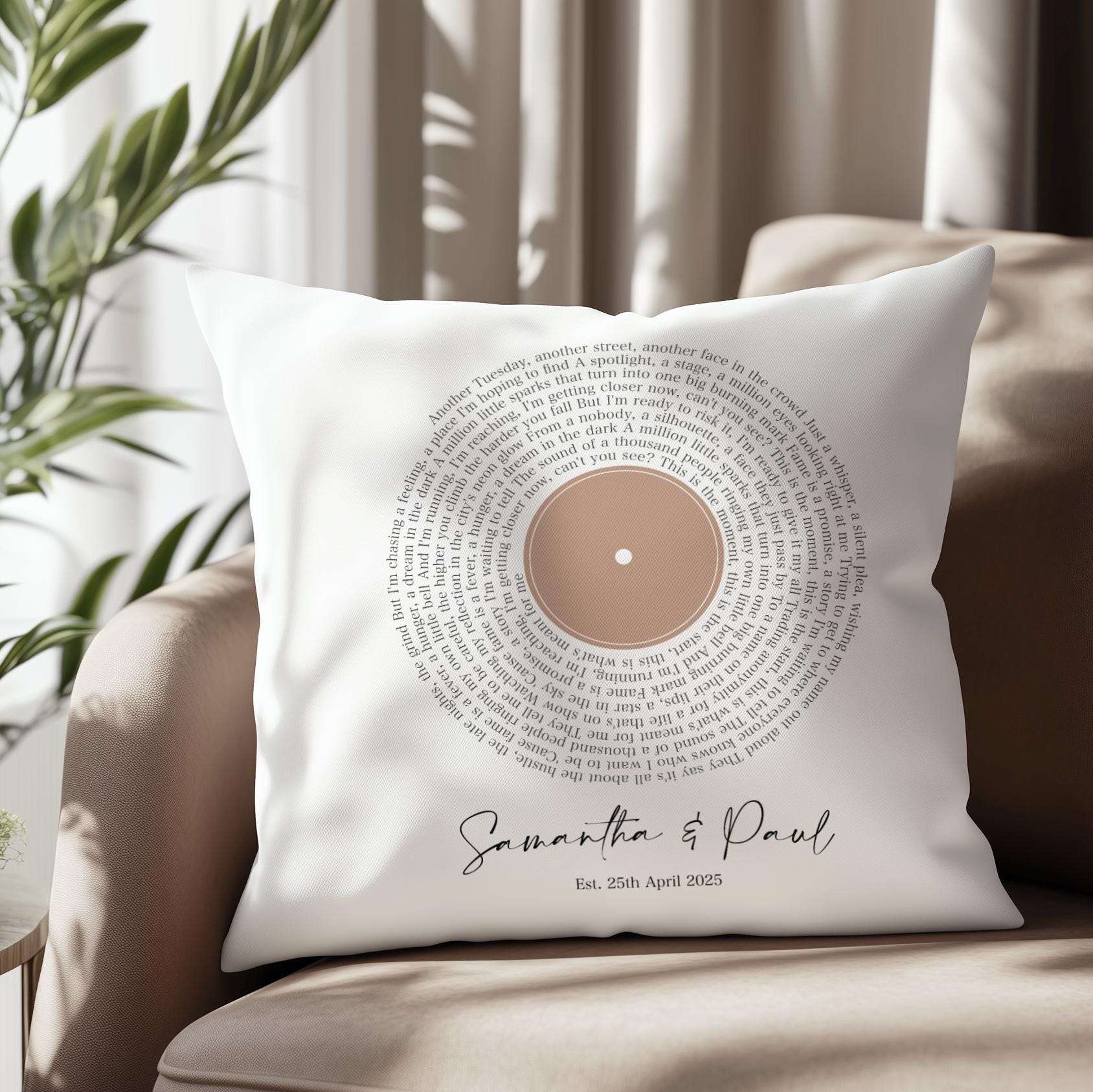 Custom cushion featuring first dance song lyrics in a spiral vinyl record design, personalised with names and date